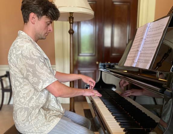 Jonathan Beatty playing the grand piano at Castle Coole