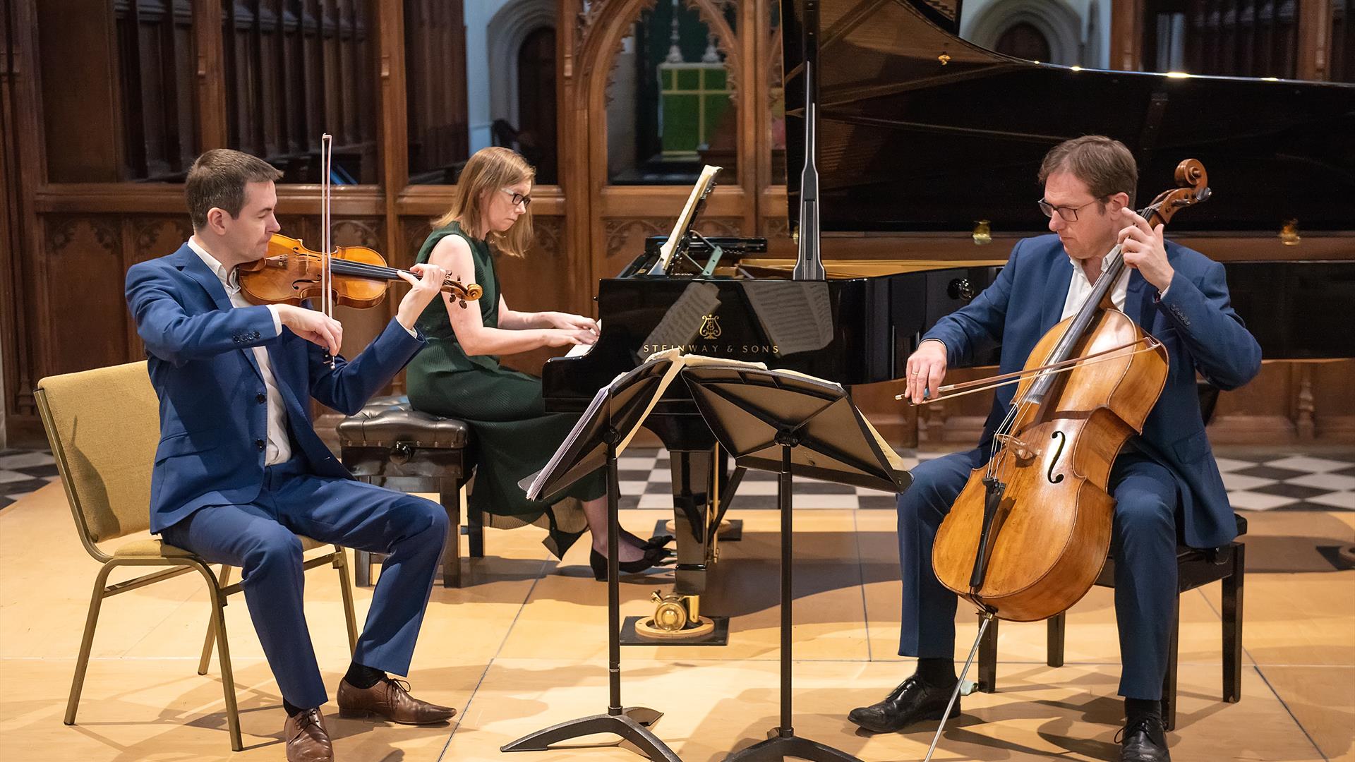 The Fidelio Trio pianist, violin and cello are shown mid performance