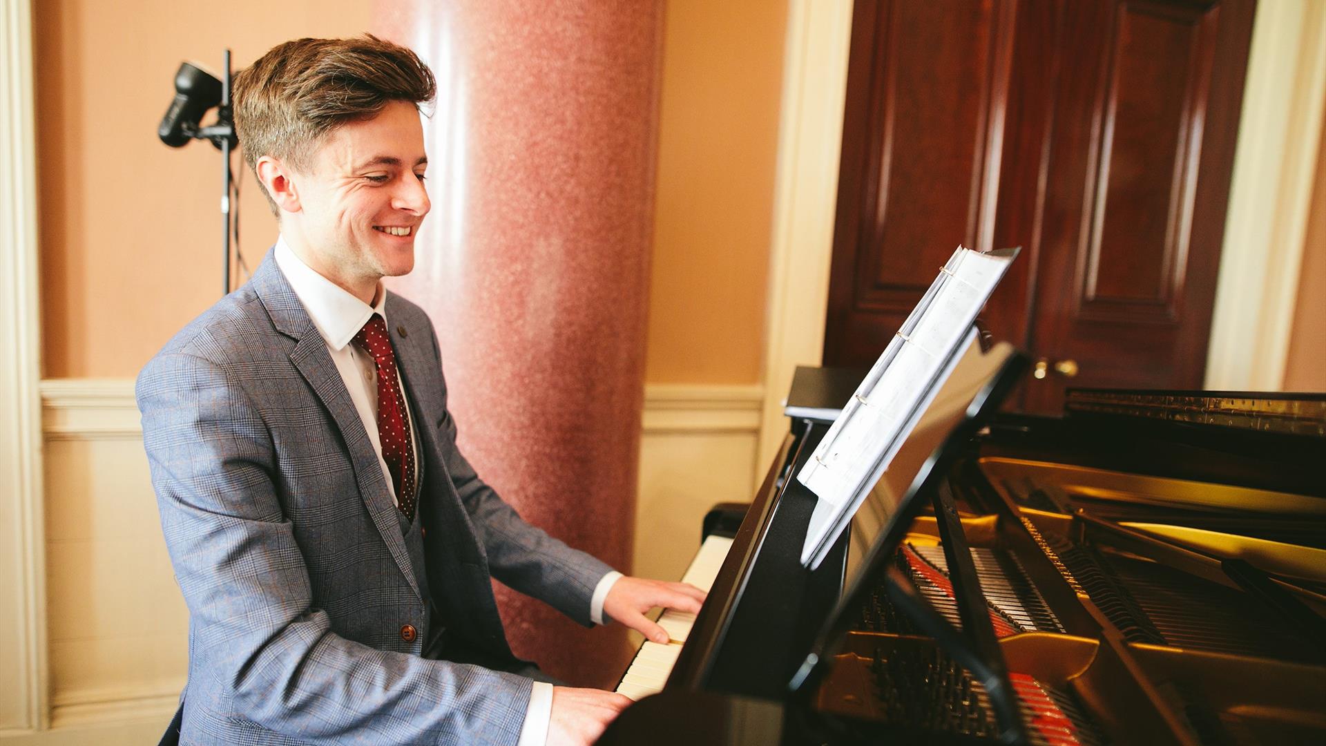 Jonathan Beatty playing the piano at Castle Coole