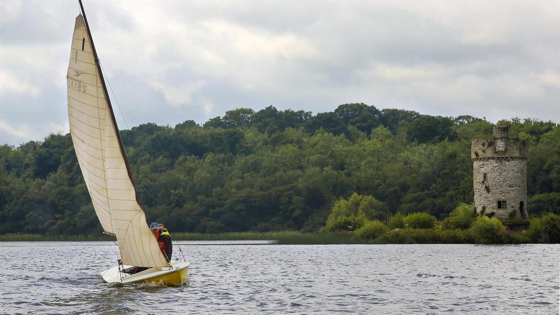 A snipe dinghy sailing at Crom with Gad Tower in the background