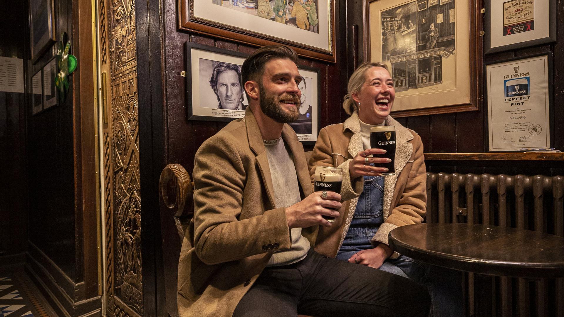 2 people enjoying a Guinness in Blakes of the Hollow