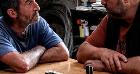 2 men playing dominoes