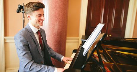 Jonathan Beatty, playing the piano in the Entrance Hall at Castle Coole