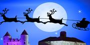 Santa's sleigh and reindeers flying over Enniskillen Castle & Watergate poster