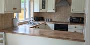 Picture of bathroom showing velux window, toilet, shower and the edge of the sink