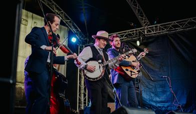 three musicians onstage at bluegrass omagh 2022